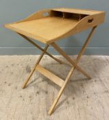 A mid-century teak desk on stand, by Heal's of London, with three pigeon holes over writing surface,