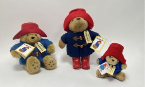 A small Eden Paddington bear wearing a felted red hat and tags (h. 18cm), a larger example with