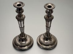 A 19thc Sheffield plated pair of weighted table candlesticks of tapered and fluted design on