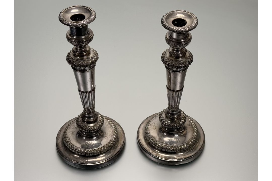 A 19thc Sheffield plated pair of weighted table candlesticks of tapered and fluted design on - Image 1 of 3