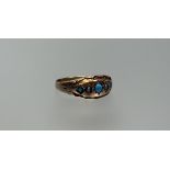 A Chester 9ct gold ring set three graduated turquoise cabouchon beads with two seed pearl spacers