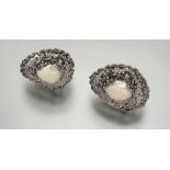 A pair of Victorian Birmingham silver heart-shaped ribbon and bow nut dishes with chased pierced