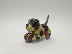 A vintage-style tin plate dog with wheels and ball to front, movement working with original box (