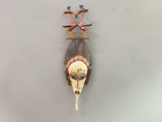 An African Tribal carved wooden mask with polychrome intricately carved top with wall hanging string
