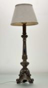 A tasteful wooden table lamp, in silver distress paint raised on three scroll feet with mirror