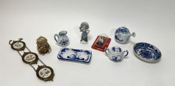 A collection of miscellaneous items comprising, a hanging trio of embroidered flowers encased within