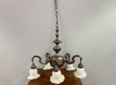 A patinated brass Art Nouveau style four-arm chandelier with four frosted fluted glass shades,