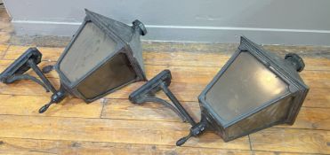 A pair of reproduction wall lights in the Victorian street light style with glass panels and wall