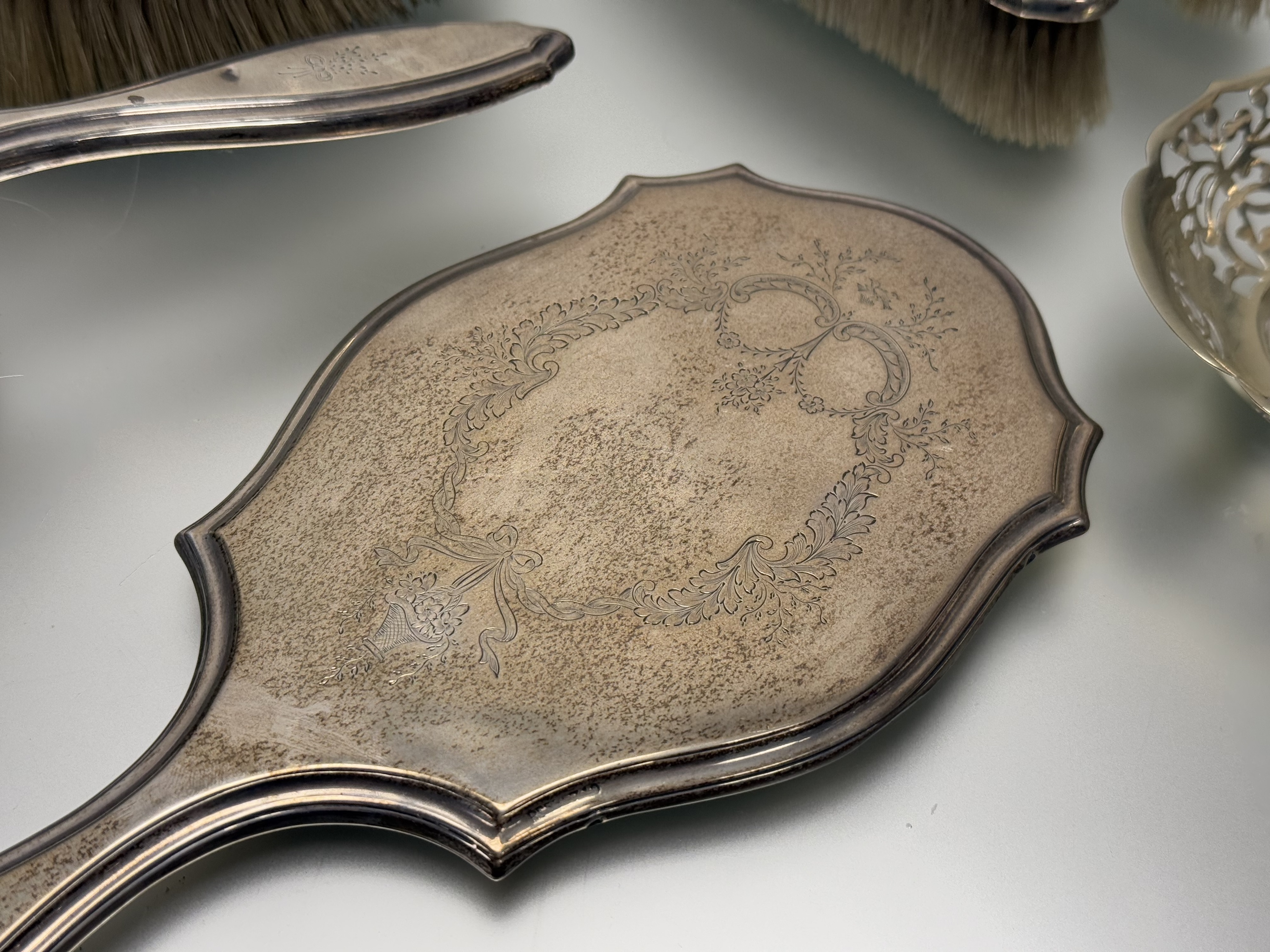 A London silver five-piece ribbon and floral swag engraved dressing set to include a hand mirror: l. - Image 2 of 6