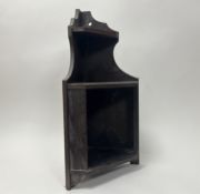 A stained wooden corner display cabinet of three levels, with shaped edge and pierced wall hanging