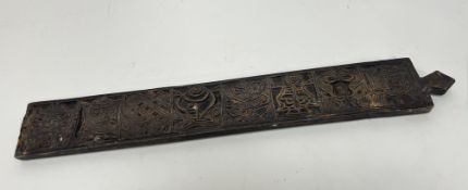 A hand-carved wooden mangle board with eight panels of varying carved decoration and a finial to top