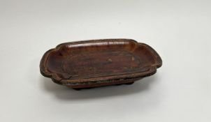 An early 20thc Chinese wooden lacquered footed serving dish with shaped edges and beaded rope border