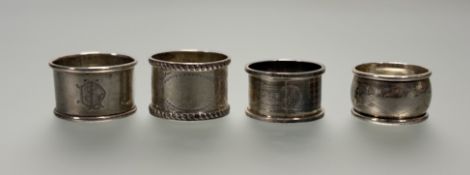 A collection of four silver napkin rings to include three Birmingham napkin rings and a Chester