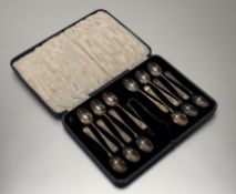 A Sheffield silver set of twelve tea spoons and tongs with engraved letter F in original black