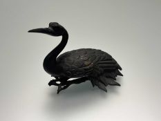 A Japanese bronze in the form of a seated Crane figure circa meiji period. (h-10cm)
