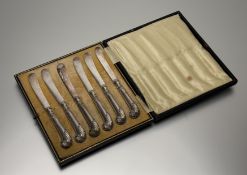 A Sheffield set of six silver pistol handled steel bladed tea knives in original fitted soft gold