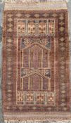 A Persian Baluchi prayer rug, central panel with architectural arches enclosed within repeating
