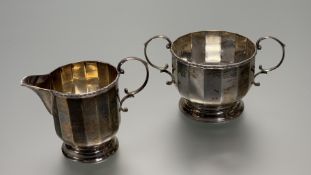 A George V Birmingham silver two piece morning tea set comprising a panel siuded two handed sugar