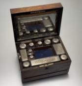 A Victorian walnut toilet case with hinged top with mirror panel - loose enclosing a collection of