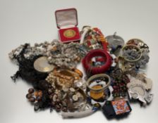 A box containing a large collection of costume jewellery to include a necklace, paste pearls and