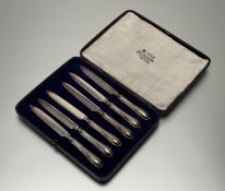 A Sheffield set of six silver handled fruit knives with epns blades in original blue velvet-lined