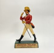 A vintage Johnnie Walker counter top advertising figure by Harry E. Tunnicliffe, with walking