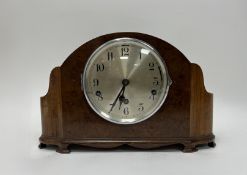 An Art Deco style bur walnut and mahogany mantle clock with Westminster chime and analog face,