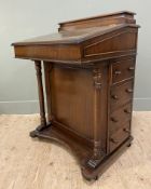 A reproduction mahogany Davenport desk, with stationary box to top over an inset leather writing