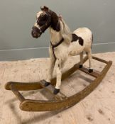 A late 19th century rocking horse, covered in real hide with horse-hair mane and tail, leather