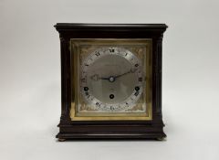 An Elliot of London mahogany cased mantle clock with silver dial, roman numerals and cast brass