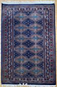 A modern hand-knotted North-west Persian rug, central panel with repeating stylized tree motifs,