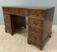 A reproduction mahogany twin-pedestal desk, with red inset leather skiver to top, over three
