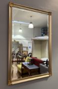 A contemporary Richmond gilt mirror, decorated with reeded and ebonised border and four foliate