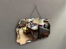 An Art Deco octagonal mirror with scalloped bevelled edge and mounting chain (l. 66cm x h. 37.5cm)