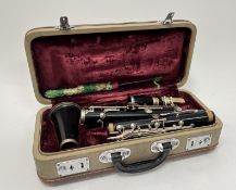A Clarinet with nickel plated mounts stamed B04745, within a leather mounted hardshell carry case (
