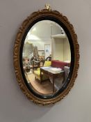 An early 20thc giltwood mirror with carved beaded frame and inner ebonized strip sorounding a