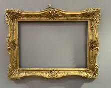 An early 20thc Chas Pettitt gilt composition frame, with corner and edge acanthus leaf scrolls and