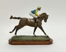 A Border Fine Arts sculpture modelled as a Racing Horse and Jockey, raised on a wooden base,