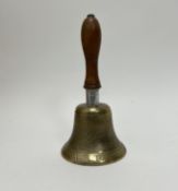 A WWII air raid precaution hand bell with ARP to front and with a turned wooden handle, makers