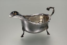 An Edwardian Birmingham George III style scalloped sauce boat with S scroll handle on triple shell