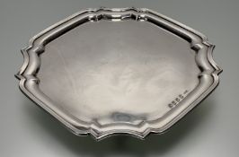 A Dublin silver salver of square scalloped form raised on four scroll supports; h. x 3cm d. x 23xm