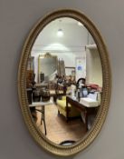 An early 20thc English gilt oval mirror with beaded border (h. 84cm x w. 58cm)