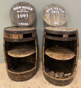 A pair of oak and metal-bound whisky barrels, converted to bar tables, with cut-outs to front and