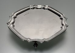 A George V Sheffield silver scalloped drinks serving tray raised on four scroll feet: h. x 3cm d.