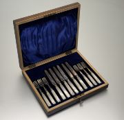 A George V Sheffield set of six pairs of silver bladed mother of pearl fruit knives and forks in