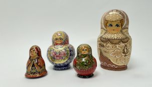 A collection of Russian Babushka dolls, each with intricate dotted decoration and gilt decoration (