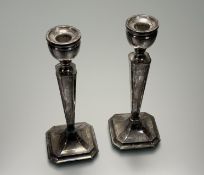 A pair of Birmingham silver-weighted octagonal tapered column table candlesticks on stepped bases: