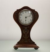 An Edwardian Mahogany Art Nouveau mantle clock, with carved brass metal inlay, and Swiss made