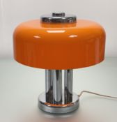 A Retro 1970's chrome metal table lamp with orange mushroom acrylic shade, raised on three chrome