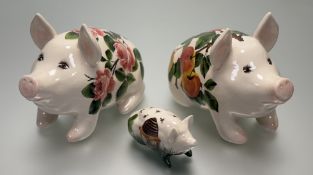 A trio of Griselda Hill Pottery Wemyss pigs, one painted with pink roses (h-21cm), the other with an